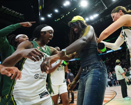 Seattle Storm center Awa Fam, center, celebrates with guard Flau’jae Johnson, left and guard Jade Melbourne, right after a win over the Connecticut Sun in a WNBA basketball game, Friday, May 22, 2026, in Seattle.