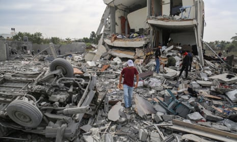 Palestinians search rubble after a bombardment west of the Nuseirat refugee camp in the central Gaza Strip
