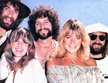 L-R: Mick Fleetwood, Stevie Nicks, Lindsey Buckingham, Christine McVie and John McVie, all smiling broadly, in about 1975.