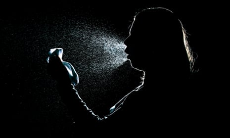 Silhouette of a woman sneezing and spreading virus droplets in the air
