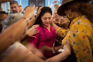 Cinthya Santos-Briones ‘Living in Sanctuary’  Amanda Morales, center, is blessed by the members of Holyrood church congregation, where Amanda and her family have been living in sanctuary since 2017. Amanda took refuge in Holyrood Episcopal Church in Washington Heights, Manhattan with her three children for fear of being deported. She had been living in New York since 2004. Since 2012, Amanda had been under supervision with immigration authorities and was complying with all that she was asked. In early May she was told to present herself with one-way ticket to Guatemala, on August 17, 2017 to be deported.