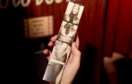 a person holds their photo booth strip