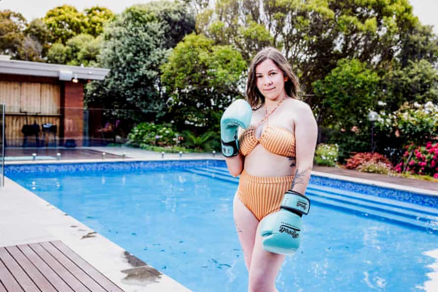     Alison Cheney wearing boxing gloves by the pool