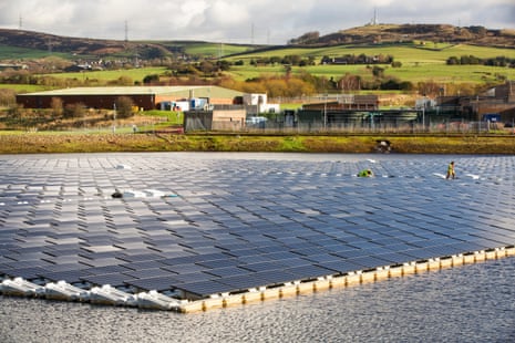 The new floating solar farm being grid connected on Godley reservoir in Hyde, Manchester, UK.