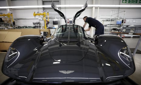 An employee works on the interior of an Aston Martin Valkyrie.