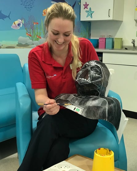 Lobke Marsden paints a radiotherapy mask.