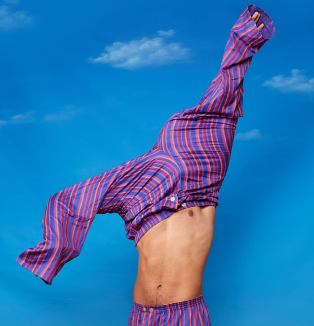 Man wearing one pair of pyjama bottoms and pulling another pair on over his head
