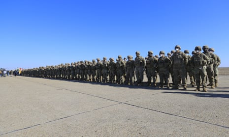 US troops line up to meet the Nato secretary general, Jens Stoltenberg, at the military airbase of Mihail Kogalniceanu, Romania, 11 February 2022.