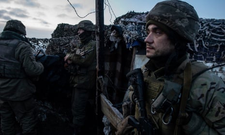 Ukrainian soldiers stand guard