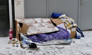 cardboard box and sleeping bag on snow-covered street in Windsor, Berkshire