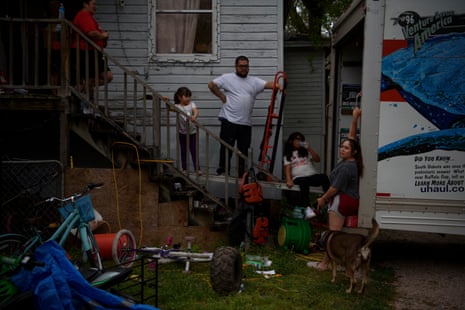 Mark Aleman, Mendoza’s brother-in-law, holds up a dolly as he loads belongings into a moving van in the Allen Field subdivision in Houston, Texas, on 29 March 2022. Their home is across the street from the home Mendoza moved out of recently.