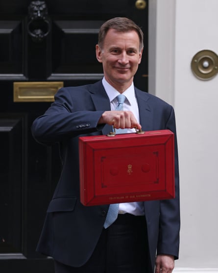 Jeremy Hunt holds up a red dispatch box outside No 11 Downing Street