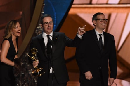 Writer/producer Tim Carvell (R) and TV host John Oliver (C) accept Outstanding Variety Talk Series for Last Week Tonight with John Oliver.