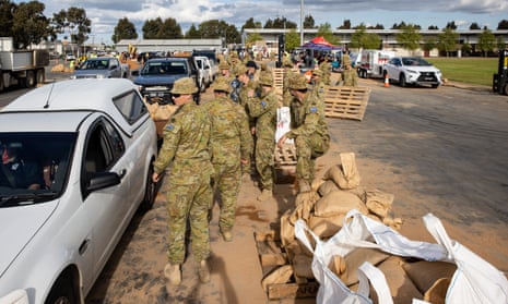 Australian defence force personnel load residents’ cars with sandbags in Shepparton, Victoria on Sunday.
