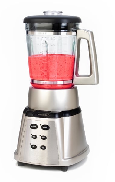 A high speed blender with a pink smoothie inside