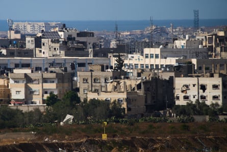 buildings with the sea in the background and a single yellow block in the foreground
