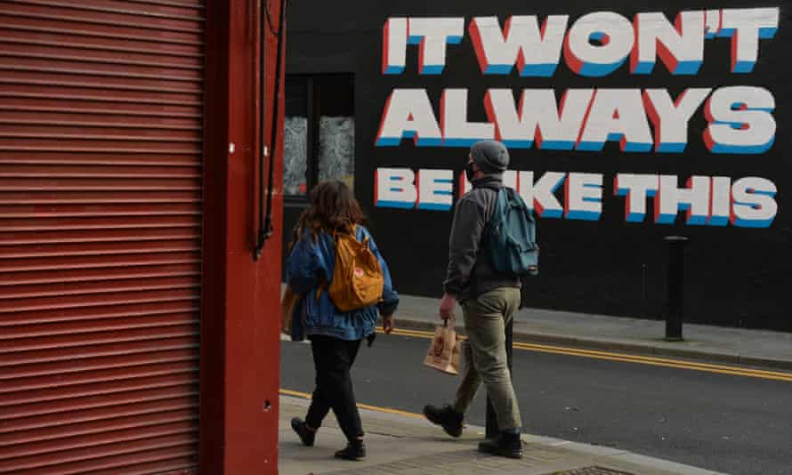 People walk past a mural by Irish artist Emmalene Blake in Dublin city center.