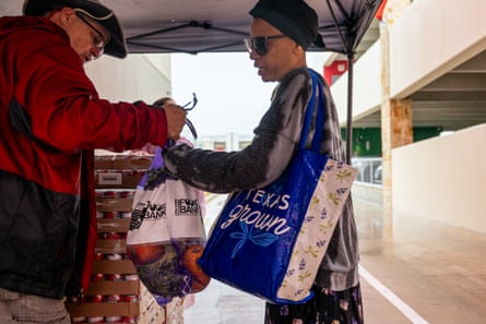 a person giving a women oranges