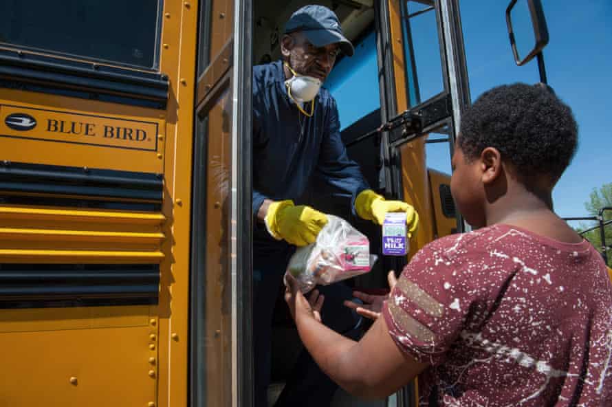Robert King, transportation supervisor for Holmes County Consolidated School District, delivers school lunches to student Keizarrian Thomas, in Lexington, Mississippi, on April 1, 2020.