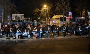 Protesters spell out the phrase ‘women’s rights’ in Polish at a rally outside parliament in Warsaw