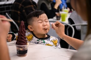 Boy eating purple ice cream
