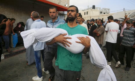 Relatives mourn after bodies of Palestinians killed in an Israeli attack on Nuseirat camp are brought to Al Aqsa Martyrs Hospital.