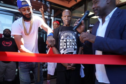 Nipsey Hussle, left, at the grand opening of The Marathon Clothing store in 2017.