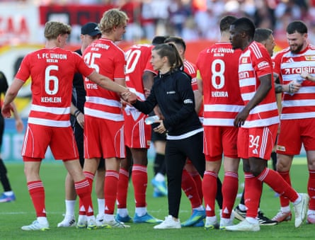 Marie-Louise Eta (centre) speaks to her Union Berlin players during a break in play