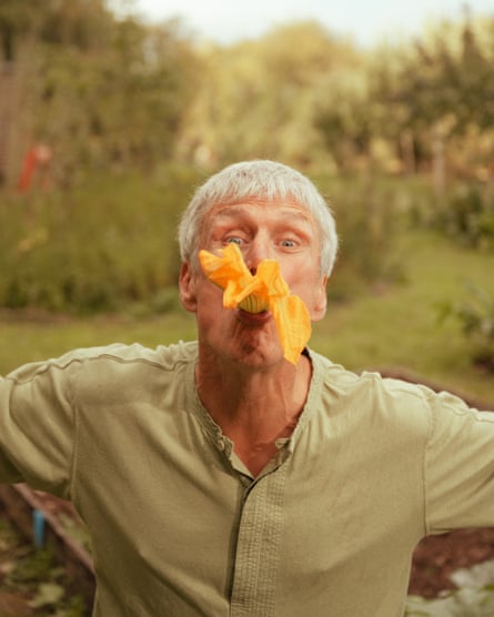 Bez, photographed at home in Herefordshire, with a yellow flower in his mouth.