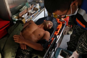 Liu Zi-Xian, 25, has his blood pressure measured in an ambulance after falling ill
