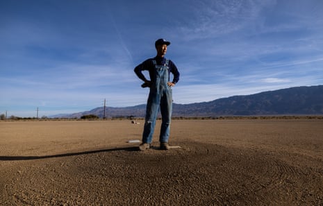 Dan Kwong stands on the old pitcher's mound at Manzanar, mountains in the distance