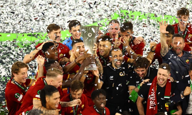 Roma's Lorenzo Pellegrini lifts the trophy as he celebrates with teammates after winning the Europa Conference League final.