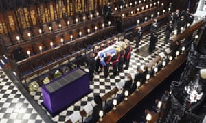 The Queen watches as pallbearers carry the coffin of the Duke of Edinburgh during his funeral at St George’s Chapel in Windsor Castle.