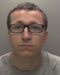 Mugshot of man with glasses