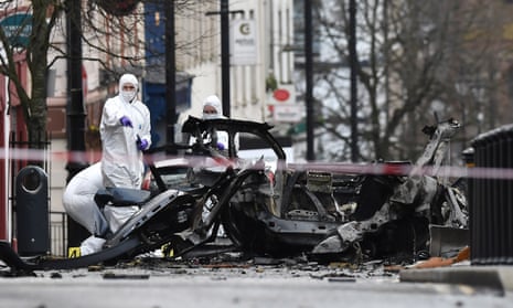 Forensic officers inspect the remains of the vehicle used in the bombing outside a courthouse in Derry