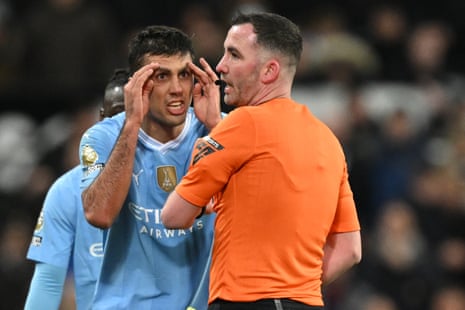 Rodri remonstrates with referee Chris Kavanagh after he receives a yellow card.