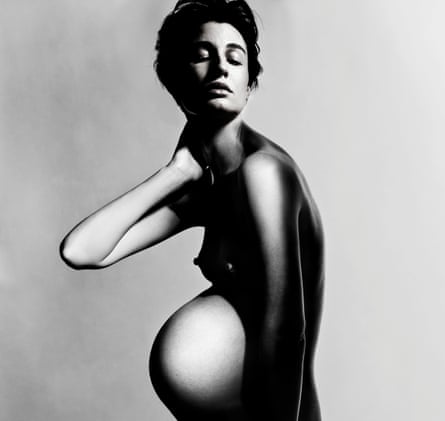 A portrait of Erin O'Connor, naked and pregnant, in black and white