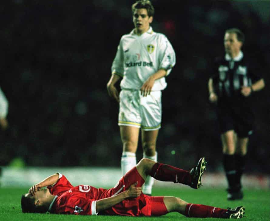 Michael Owen holds his leg in pain.