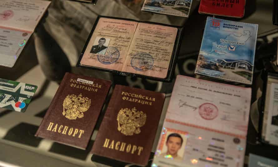 Russian passports, military records, ID cards, dog tag, credit cards on display.