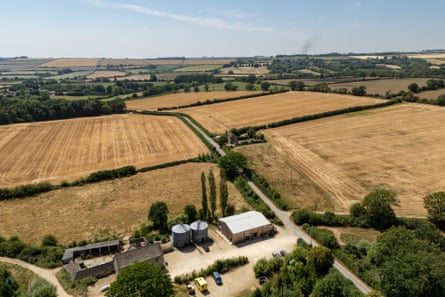 A patchwork of fields next to a farm