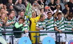 Celtic’s Callum McGregor and Joe Hart lift the trophy after victory over Rangers.