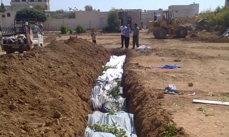 This photograph provided by the Shaam News Network shows a mass grave said to contain the bodies of victims of the Daraya massacre.
