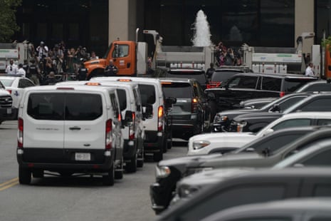 A convoy of vehicles leaves the US District Court in Washington.