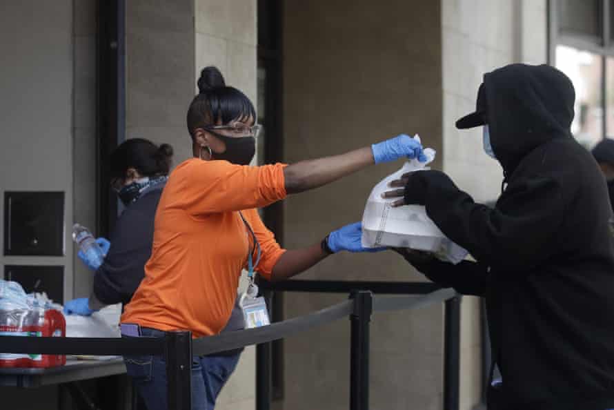 Felicia Senigar, left, hands out food in San Francisco in April.