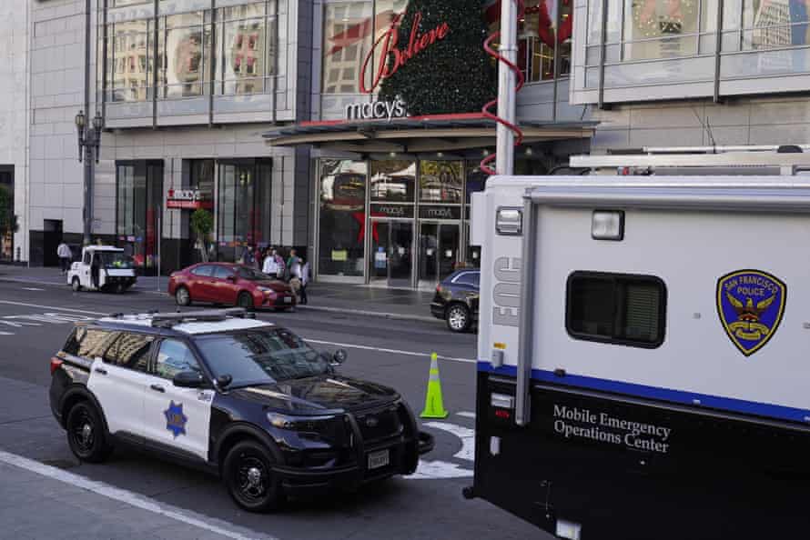 A police car is parked behind a mobile emergency unit outside of the Macy's store in San Francisco.