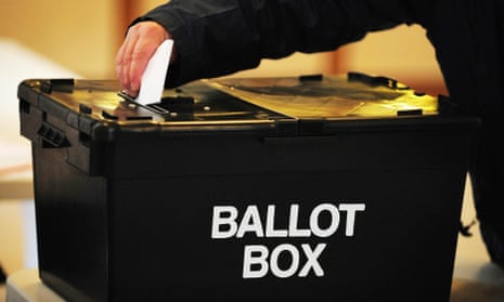 a man cast his vote into a black ballot box