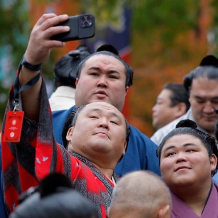 The veteran sumo wrestler Tamawashi, who is 40 years old, takes a selfie with Hakuoho on the south steps outside of the Royal Albert Hall