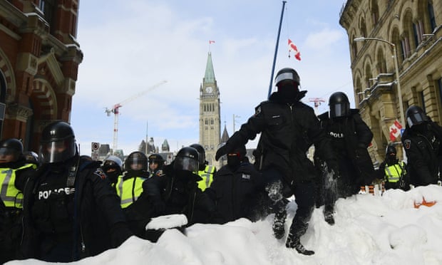 Ottawa: police use pepper spray and stun grenades to clear trucker protest | Canada | The Guardian