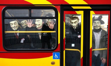 Protestors wearing masks on a bus.