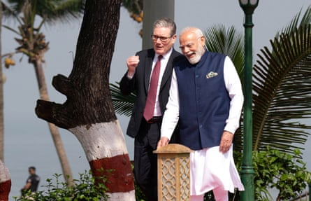 The Indian prime minister, Narendra Modi, and his UK counterpart, Keir Starmer, walk in the gardens of Raj Bhavan, in Mumbai, India, on Thursday.